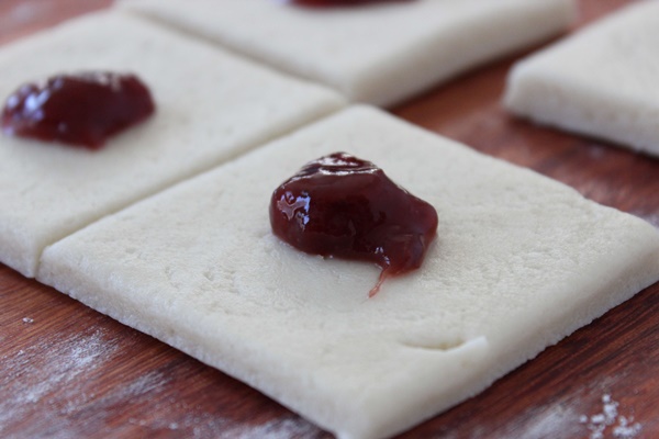 Strawberry pinch cookies recipe- roll out the dough and top with strawberry preserves